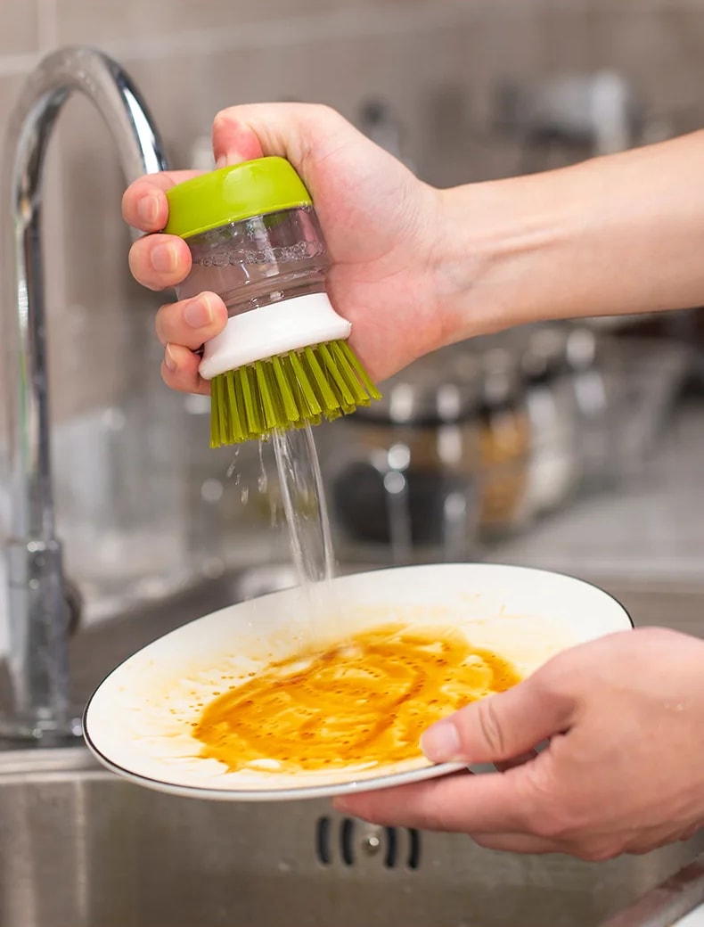 Scrubbing a dirty plate with the Jalenza brush